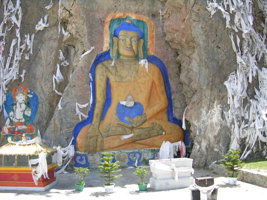 01-2 Shakyamuni Buddha Shakyamuni is the title of Gautama Buddha, sage of the Shakya tribe. He is usually shown seated on a lotus throne, legs crossed, palm inward with the fingertips of his right hand touching the earth, and his left hand in his lap holding a bowl. His head reveals fixed marks of identity: a bump of wisdom on top of his head, often crowned with a precious jewel; three auspicious lines on his neck; ear lobes elongated and split; and a dot in the centre of the forehead, symbolizing the third eye of spiritual wisdom.